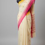 Off-white with magenta monipuri saree.